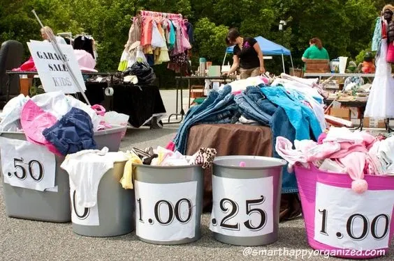 LILBURN, GA – APRIL 2012: Shoppers look over merchandise on sale for dirt cheap prices at the Lilburn citywide garage...