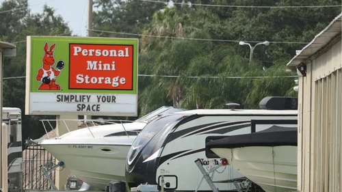 personal mini storage sign next to rvs and boats